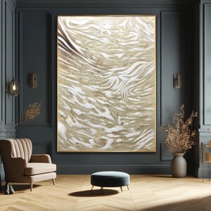 May include: Large abstract art piece with a gold frame. The artwork features a swirling pattern of beige and white, creating a marbled effect. The piece is displayed in a room with dark teal walls and a wooden floor.