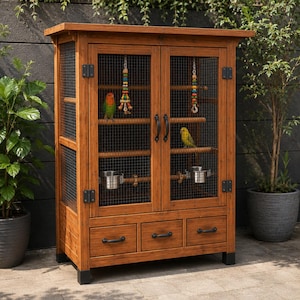 May include: A tall, rectangular wooden bird cage with a natural brown finish, featuring two mesh-covered doors, three bottom storage drawers with black handles, two internal metal feeding bowls, wooden perches, and colorful hanging bird toys.
