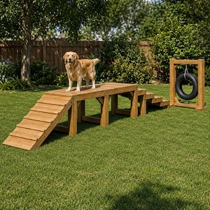 May include: A golden retriever stands on a wooden dog agility course featuring a ramp, a raised platform, a set of stairs, and a black tire suspended from a wooden frame. The structure is made of light brown wood and is set on a green lawn.