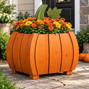May include: A pumpkin-shaped wooden planter constructed from vertical orange-toned wood slats. The planter features a green wooden stem and a green leaf accent, and it is filled with a vibrant arrangement of orange and yellow chrysanthemum flowers.