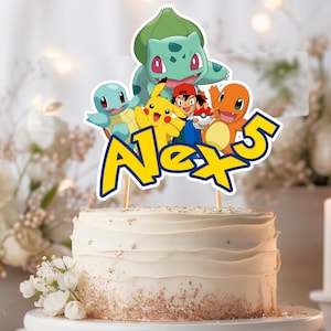 May include: A white frosted cake with a decorative topper featuring cartoon characters and the name "Alex 5" in yellow and blue. The topper includes characters like Pikachu, Bulbasaur, and Charmander. The cake is decorated with gold sprinkles.