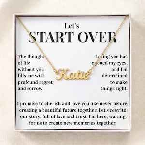 May include: A gold-toned name necklace featuring the name Katie in a cursive script font, displayed inside a white gift box. The box insert includes the text Let's START OVER and a printed message about regret, love, and creating a new future together.