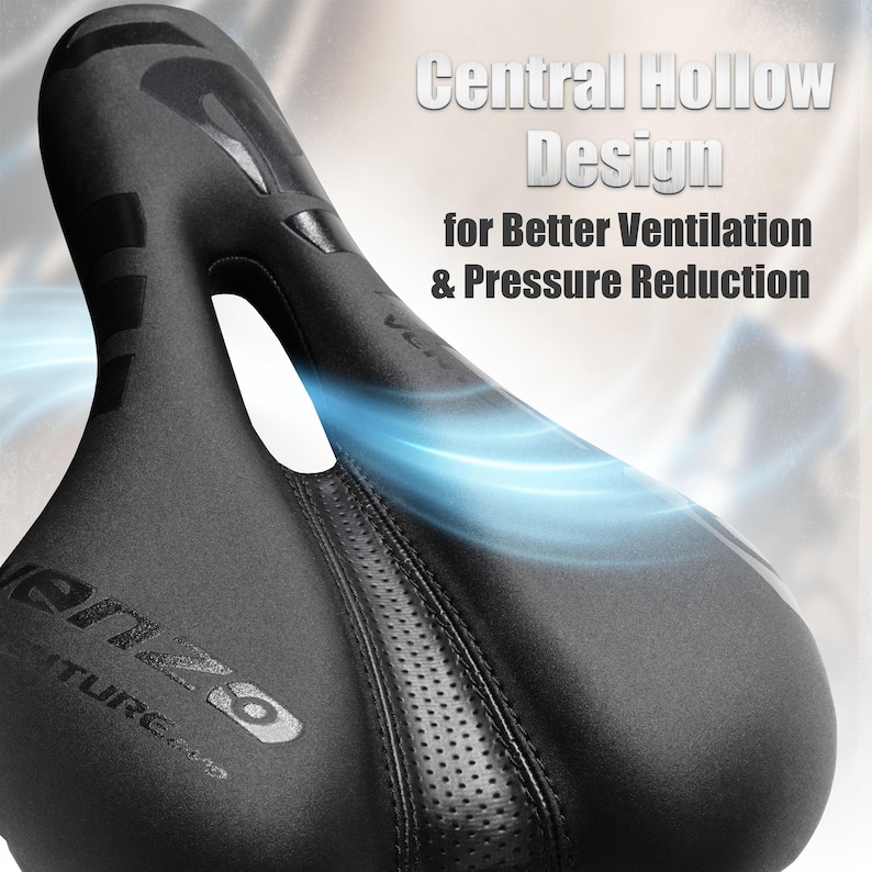 May include: Black bicycle seat with a central hollow design for better ventilation and pressure reduction. The seat has a textured surface and the text "Central Hollow Design for Better Ventilation & Pressure Reduction". The seat has the brand name "Venzo" printed on it.