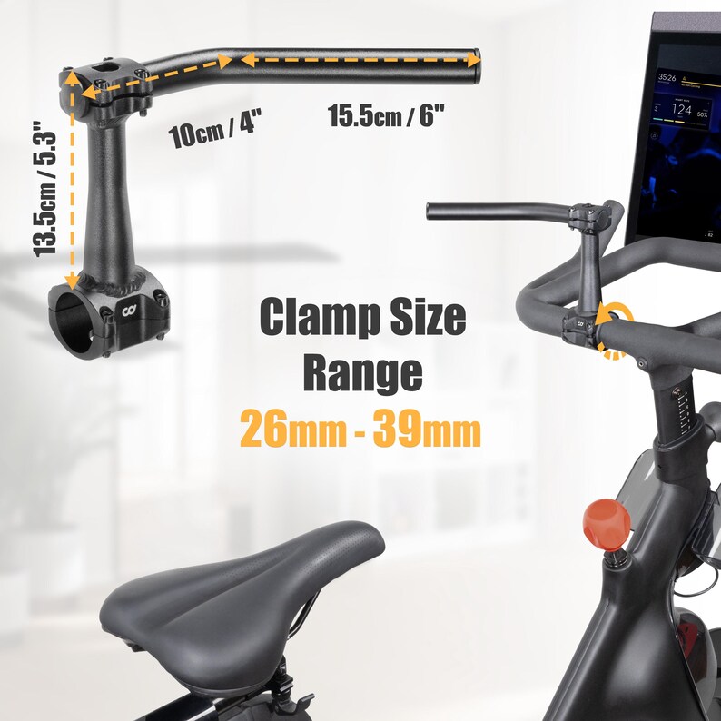 Puede incluir: Manillar negro de bicicleta est&aacute;tica con medidas de 10cm/4", 15.5cm/6" y 13.5cm/5.3". Se muestra el texto "Clamp Size Range 26mm-39mm". Tambi&eacute;n se ven el asiento y la pantalla de la bicicleta.