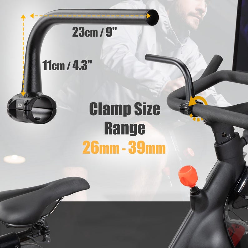 May include: Black exercise bike handlebar with dimensions of 9 inches long and 4.3 inches high. The clamp size range is 26mm-39mm. The handlebar is designed for exercise bikes and is shown with a portion of the bike's frame.