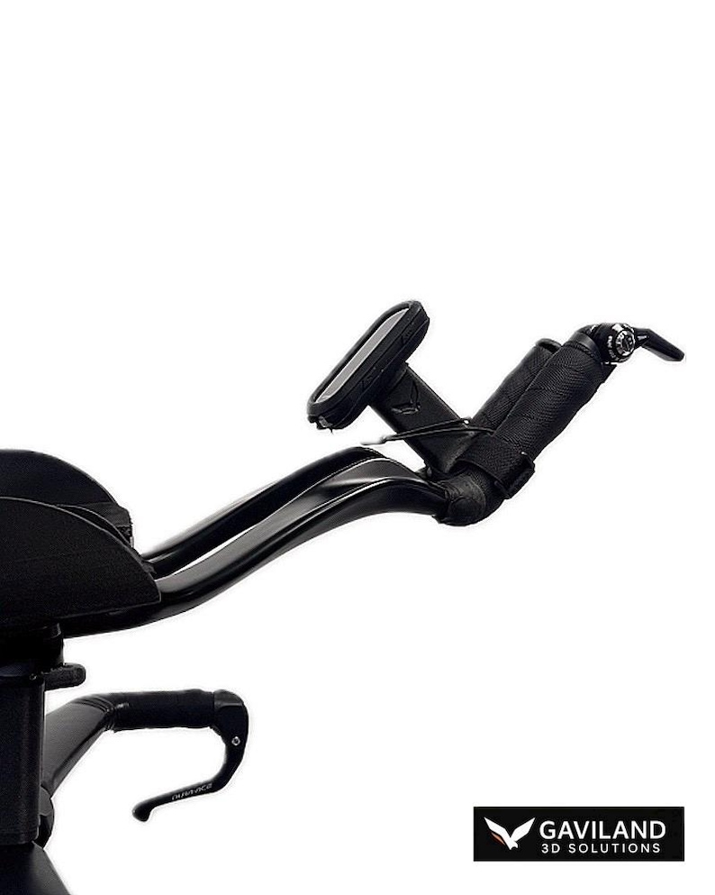 May include: Black bicycle handlebars with a padded grip and a small computer display. The handlebars curve gracefully, with a sleek, modern design. The image is set against a white background.
