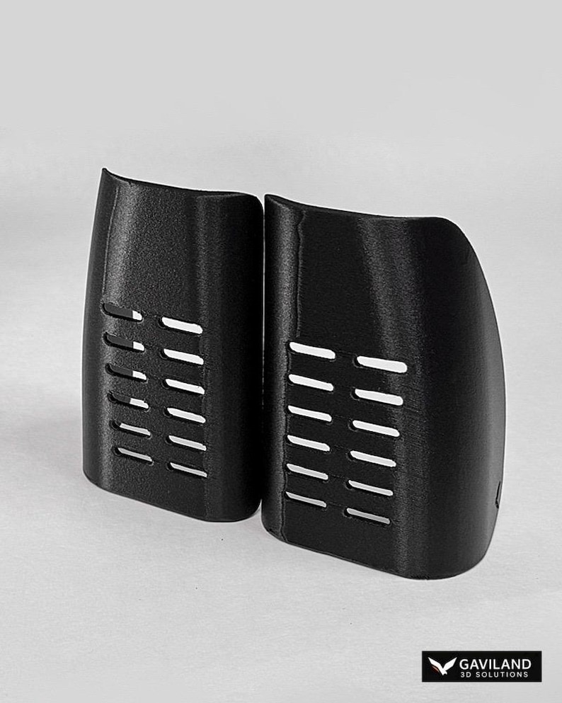 May include: Two black, curved, 3D-printed plastic components featuring a series of horizontal ventilation slots. Each piece has a textured surface and a rounded, asymmetrical shape. The logo GAVILAND 3D SOLUTIONS is visible in the bottom corner.