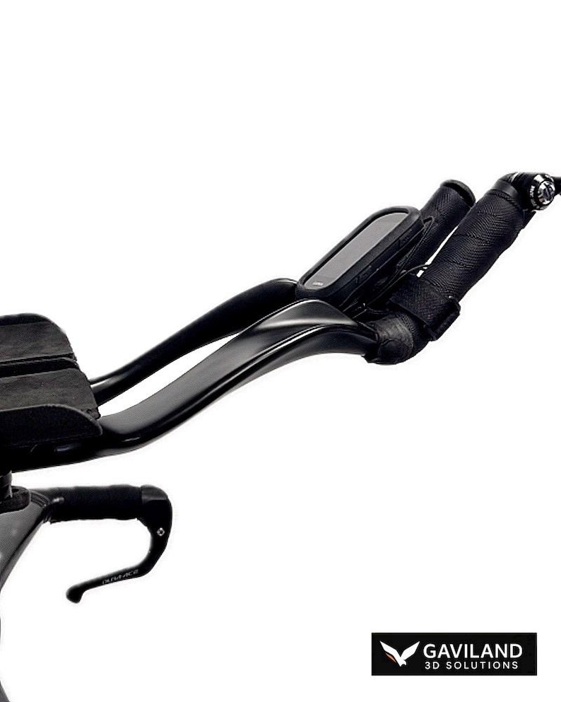May include: Black triathlon bike handlebars with integrated armrests and a cycling computer. The handlebars have black tape. The image is set against a white background. The Gaviland 3D Solutions logo is in the bottom right corner.