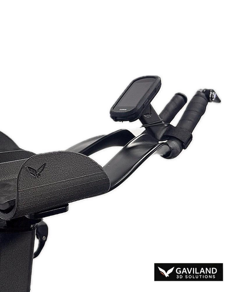 May include: Black bicycle handlebars with a mounted black device and black grips. The handlebars have a curved design and a logo on the side. The image is set against a white background. The logo says "GAVILAND 3D SOLUTIONS".
