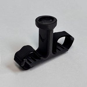 May include: A black bicycle computer mount with a circular top and a strap for securing to handlebars. The mount is designed to hold a cycling computer and is made of a textured material. The Gaviland 3D Solutions logo is in the bottom right corner.