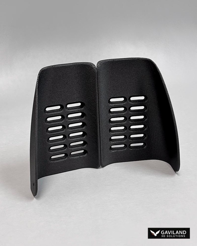 May include: A pair of black, curved, semi-rigid guards featuring a textured surface and two vertical columns of six rectangular ventilation slots each. The bottom corner of the left guard has a small circular hole. The logo GAVILAND 3D SOLUTIONS is visible.