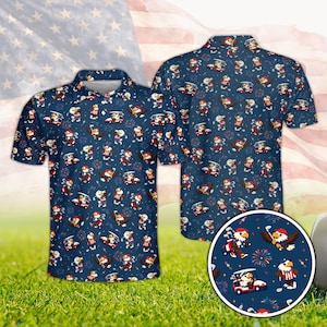 May include: Navy blue polo shirt with a repeating pattern of cartoon eagles playing golf, fireworks, and golf carts. The shirt has a white collar and buttons. The background features an American flag.