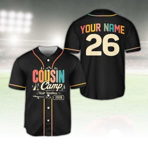 May include: Black baseball jersey with the text "COUSIN CAMP" in colorful letters and a camping graphic on the front. The back of the jersey has "YOUR NAME" and the number "26". The jersey has orange, yellow, and teal accents.