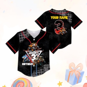 May include: Black baseball jersey with red trim, featuring monster truck graphics and the text "JASON'S 3RD BIRTHDAY". The back of the jersey has the text "YOUR NAME" above a large number 3 with a monster truck design.