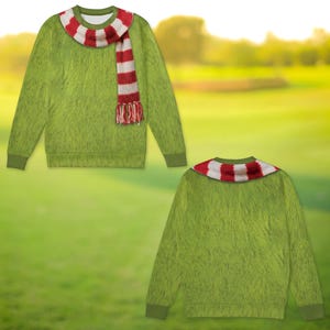 May include: A long-sleeved crewneck sweatshirt featuring a green fur-like texture print across the entire garment. The neckline is adorned with a printed red and white striped scarf design that hangs down the front with fringed ends.