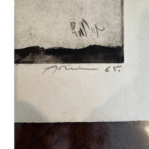 May include: A set of three ceramic mugs with a speckled, cream-colored glaze. Each mug features a different hand-painted floral design in shades of blue, green, and yellow. The mugs have a simple, rounded shape and a comfortable handle.