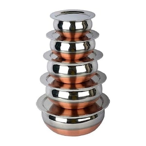 May include: A vertical stack of six round bowls with lids, arranged from smallest at the top to largest at the bottom. Each bowl features a polished stainless steel interior and rim, with a contrasting copper-toned exterior base.