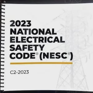 May include: A white spiral-bound book titled "2023 National Electrical Safety Code (NESC)". The cover features the IEEE SA and NESC logos, along with a graphic of a power line tower. The code is identified as C2-2023.