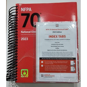 May include: A red spiral-bound book titled "NFPA 70 National Electrical Code 2023" with a matching index tab set. The book cover features the NFPA logo and the text "National Electrical Code". The index tabs are designed for easy navigation.