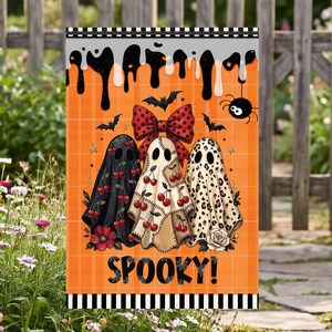 May include: A rectangular garden flag with an orange plaid background featuring three ghosts. The ghosts are decorated with cherry patterns, a large red polka dot bow, and leopard print. Black bats, a spider, and the word SPOOKY are printed.