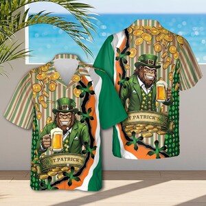 May include: A short-sleeved shirt with a St. Patrick's Day design. The shirt features a cartoon ape in a green suit and hat, holding a beer. The background has gold coins and the text "ST. PATRICK'S".