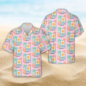 May include: A short-sleeve button-down shirt in a light pink color featuring a repeating pattern of rectangular frames. Each frame contains a yellow sun, a green palm tree, and a pink seashell. The shirt has a classic collar and a buttoned front.