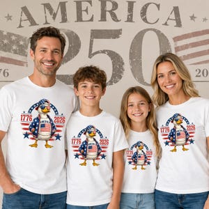 Family wearing matching America 250th anniversary shirts featuring patriotic eagle design and 1776 2026 celebration graphic.