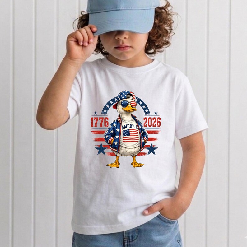 Youth wearing patriotic America 250th anniversary shirt featuring eagle artwork and 1776 2026 celebration theme.