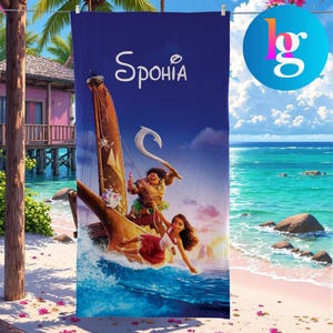 a beach scene with a large blue towel featuring a cartoon illustration of two people on a boat, with a tropical background.