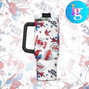 A white tumbler with a handle and a straw, decorated with a Spider-Man theme. The tumbler has a repeating pattern of Spider-Man characters and phrases, such as "SPIDER-MAN", "POW", and "POWER".