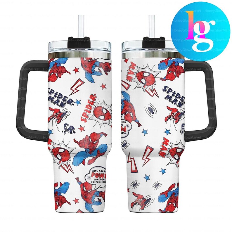 two large, white tumblers with a Spider-Man theme printed on them. The tumblers have a handle on the right side and a straw attached to the top. The design is colorful and playful, with the Spider-Man characters and other Spider-Man-related elements prominently displayed.