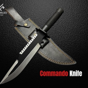 May include: A black commando knife with a silver blade, resting on a black leather sheath. The knife has a serrated edge and a black handle. The text "Commando Knife" is displayed in red.