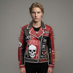 May include: A red, black, and white leather jacket with silver spikes on the shoulders and collar. The jacket features the word "Misfits" with a skull graphic, and other patches. The jacket is a punk rock style.