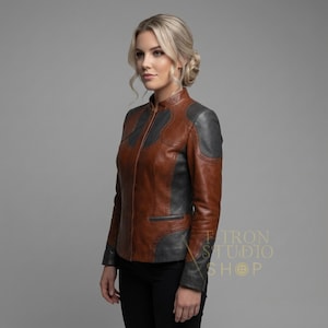 Three-quarter view of a fashion-forward women's leather jacket in cognac and charcoal gray.