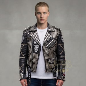 May include: Black leather jacket heavily embellished with silver studs and spikes. Features a "POLICE" patch with a skull, skull patches, and a zipper closure. A bold, edgy fashion statement.