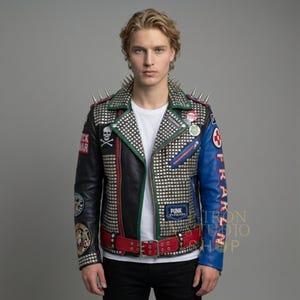 May include: A black, blue, and silver studded leather jacket with a red belt. The jacket features a skull and crossbones patch, metal spikes on the shoulders, and the word "PUNK" on a patch.