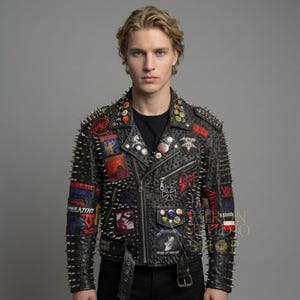 May include: Black leather jacket with silver spikes and patches. The jacket features a classic biker style with a zipper closure, multiple pockets, and a belt. Patches with band logos and other designs are sewn onto the jacket.