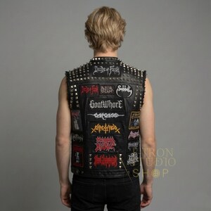 Mens black leather studded battle vest with heavy metal band patches back view.