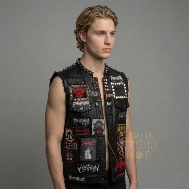 Profile view of men's custom leather vest showcasing pyramid studs and various patches.
