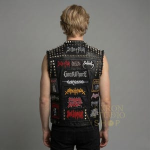 Mens black leather studded battle vest with heavy metal band patches back view.