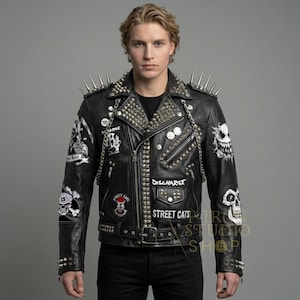 May include: Black leather jacket with silver studs, spikes, and patches. The jacket features a zipper closure, a belt, and multiple decorative patches with text and skull designs. The jacket is a classic biker style.