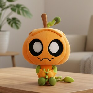 K&ouml;nnte beinhalten: Ein orangefarbener Pl&uuml;sch-K&uuml;rbis-Charakter mit gro&szlig;en schwarzen und wei&szlig;en Augen und gr&uuml;nen Akzenten. Der K&uuml;rbis hat einen braunen Stiel und eine gr&uuml;ne Ranke. Die Figur sitzt auf einer Holzoberfl&auml;che.