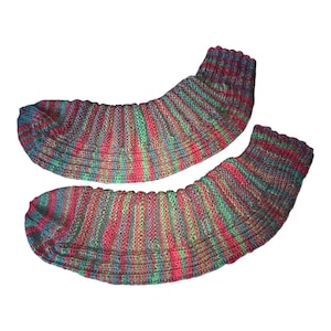 May include: A pair of knitted socks in shades of red, green, and blue. The socks have a ribbed pattern and are designed to cover the foot and ankle. The colors are blended, creating a striped effect. The socks are likely handmade.