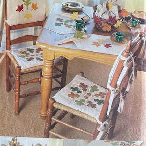 May include: A sewing pattern for a table runner, placemats, and chair cushions featuring a fall leaf design. The pattern is from Butterick and is designed by Shirley Stevenson. The pattern number is 6800.