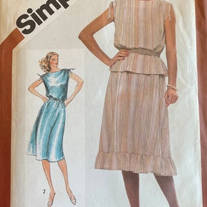 May include: Vintage Simplicity sewing pattern for a dress with a striped top and a skirt. The pattern is for size 10 miss and is from the 1970s.