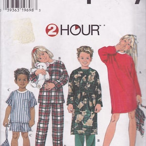 May include: A sewing pattern for children's pajamas and a robe. The pattern includes three different styles: a plaid pajama set, a robe with a dog print, and a red nightgown. The pattern is from Simplicity and is labeled "2 Hour".