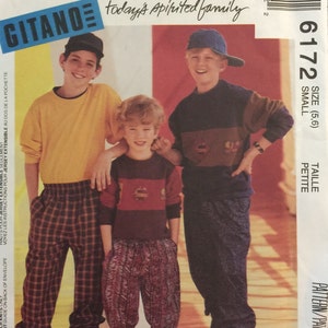May include: A sewing pattern for children's clothing from McCall's, featuring a yellow, red, and blue color scheme. The pattern is for sizes 5-6, small, and petite. The pattern is titled "Gitano" and features a photo of three children wearing the clothing.