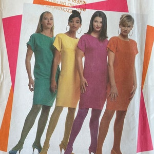 May include: Simplicity sewing pattern number 7273 for sizes 6-18. The pattern shows four women wearing different colored dresses. The dresses are all knee-length and have short sleeves. The women are wearing tights and heels.