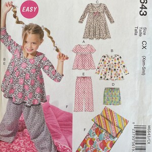 May include: Sewing pattern for children's clothing, including a dress, pajamas, and a sleeping bag. The pattern is labeled "Easy" and includes instructions for sizes X-Small to Small. The pattern is from McCall's and has the number M6643.