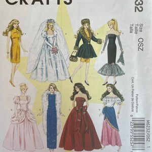 May include: A sewing pattern for making doll clothes. The pattern includes six different outfits: a white wedding dress, a black dress with a lace overlay, a red ball gown, a pink princess dress, a blue dress with a fur stole, and a pink skirt with a blue sash.